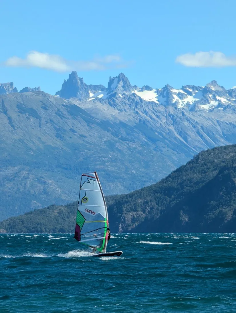Windsurf en el lago, con el cordón nevado de fondo